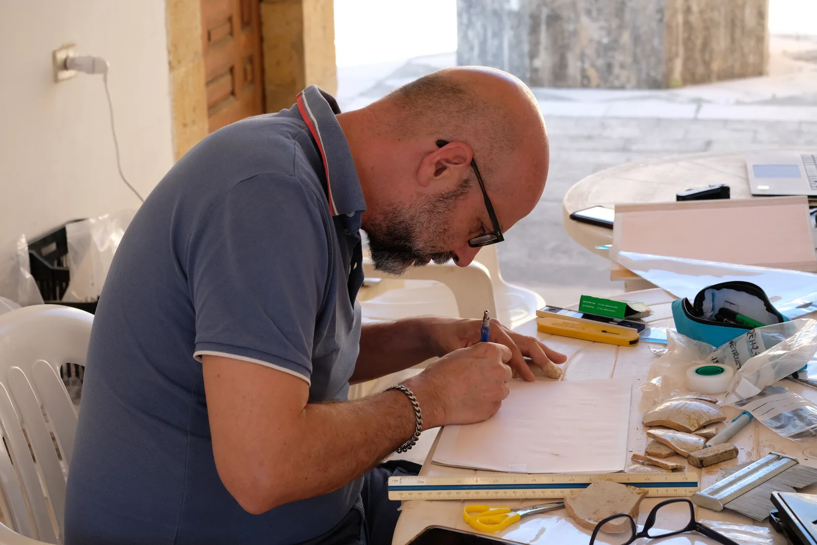 Student drawing pottery finds on graph paper