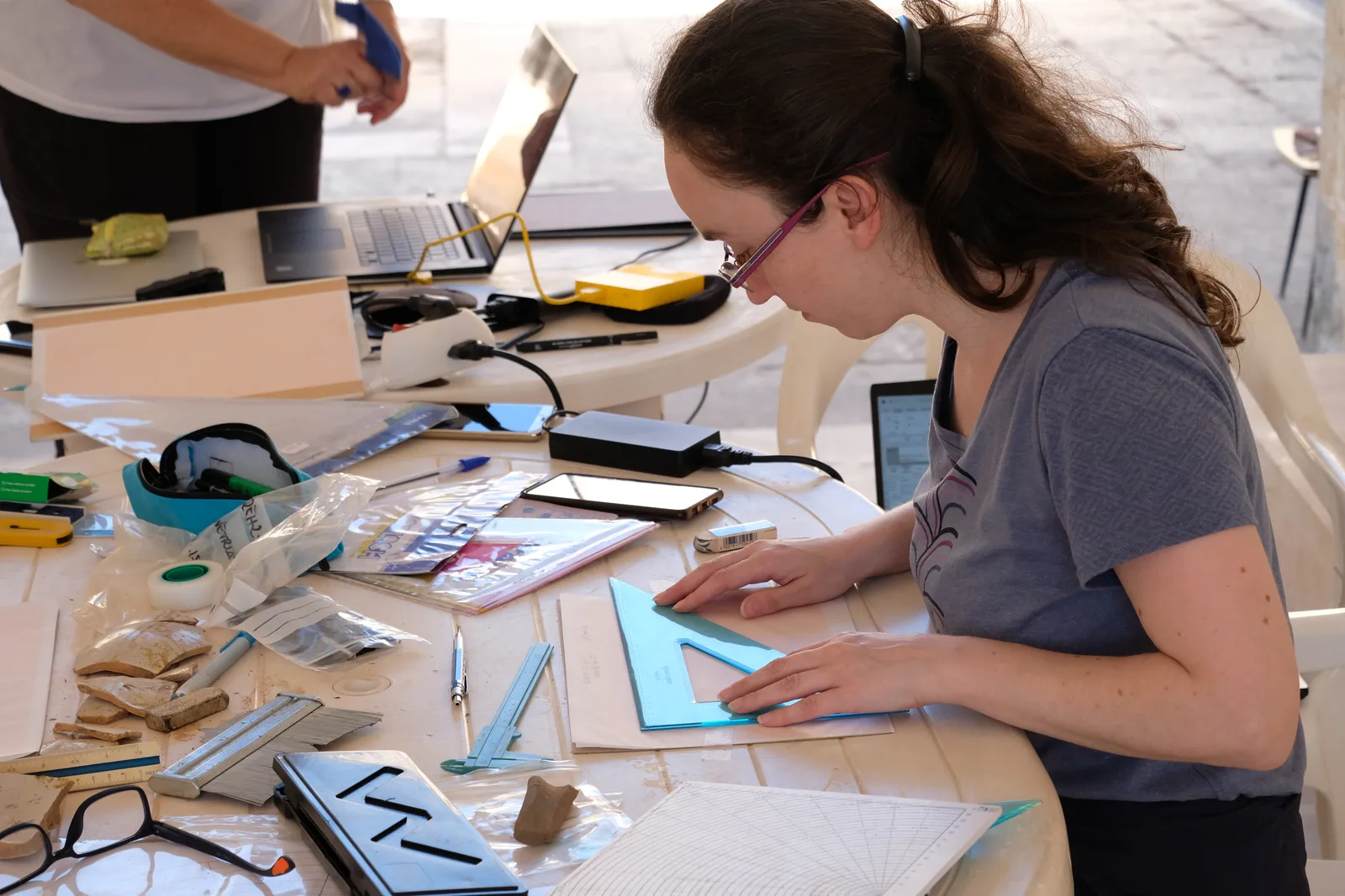 Researcher measuring a ceramic profile with a set square